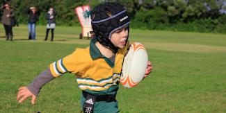 Boy playing rugby