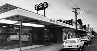 TSB Bank building in 1964 with street view and parked cars