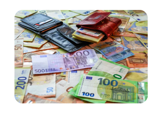 foreign money spread out across table with a wallet