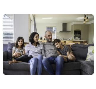 Family sitting on the sofa at home discussing Chubb life and living insurance