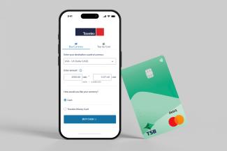 Smartphone displaying foreign currency purchase screen alongside a TSB debit card