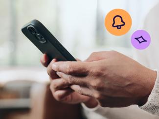 Person using a smartphone representing real-time fraud alerts and monitoring