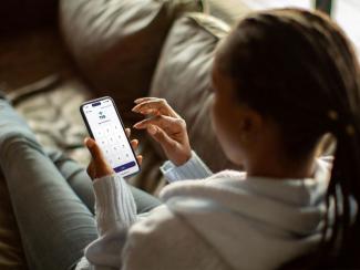 Person using a smartphone to access TSB mobile banking services.