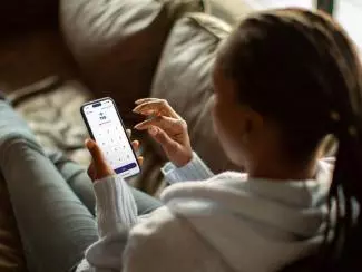Person using a smartphone to access TSB mobile banking services.