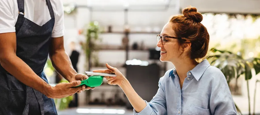 Woman paying a bill with her smart phone