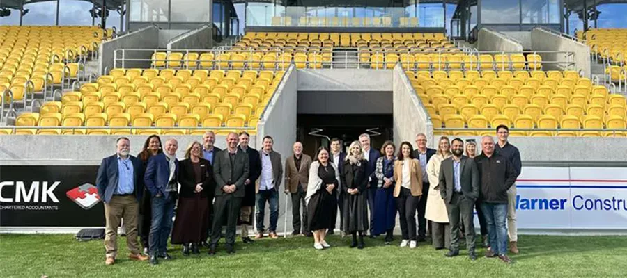 Members of TSB and Taranaki Stadium standing in a group in from of new Stadium Taranaki TSB Stand