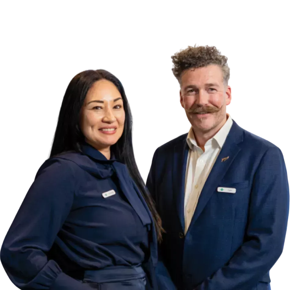 Two TSB bank staff members standing together and smiling in business attire