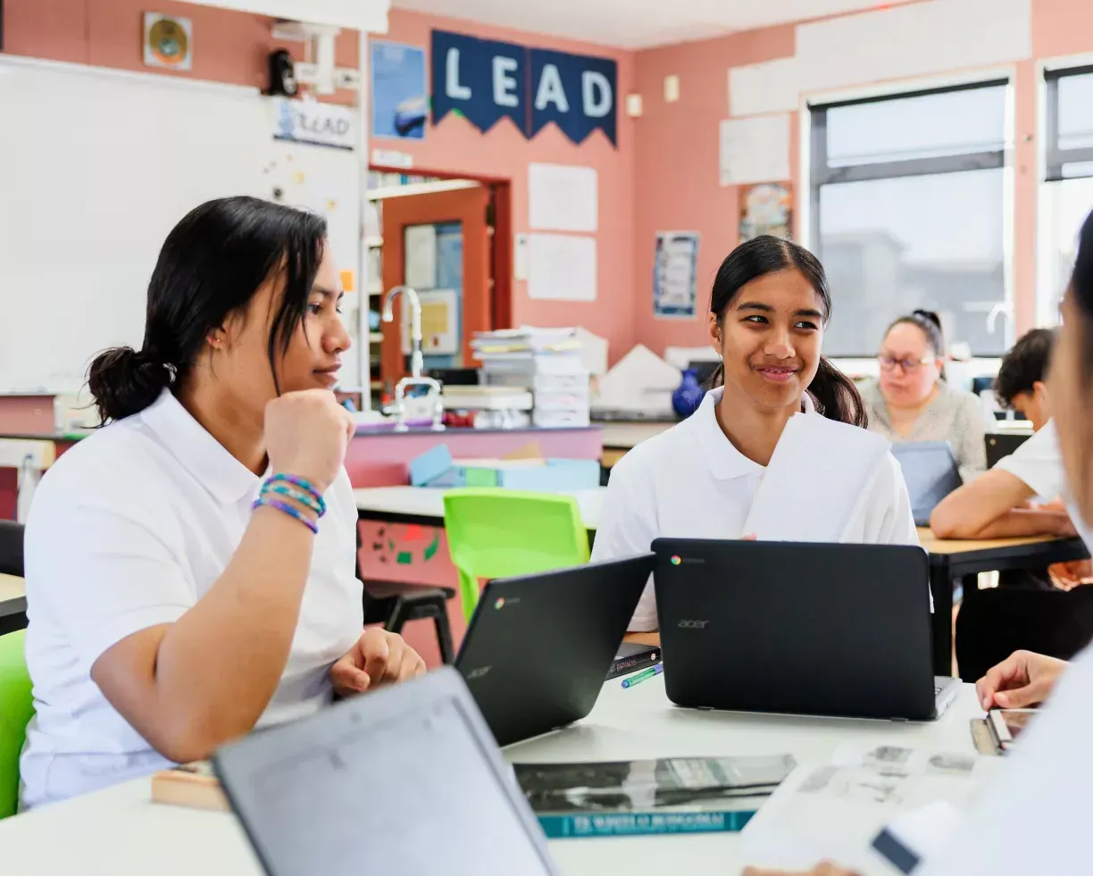 secondary school students in class sitting with laptops