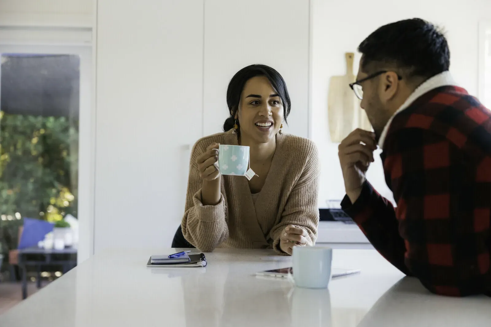 couple in the kitchen having a hot drink chatting