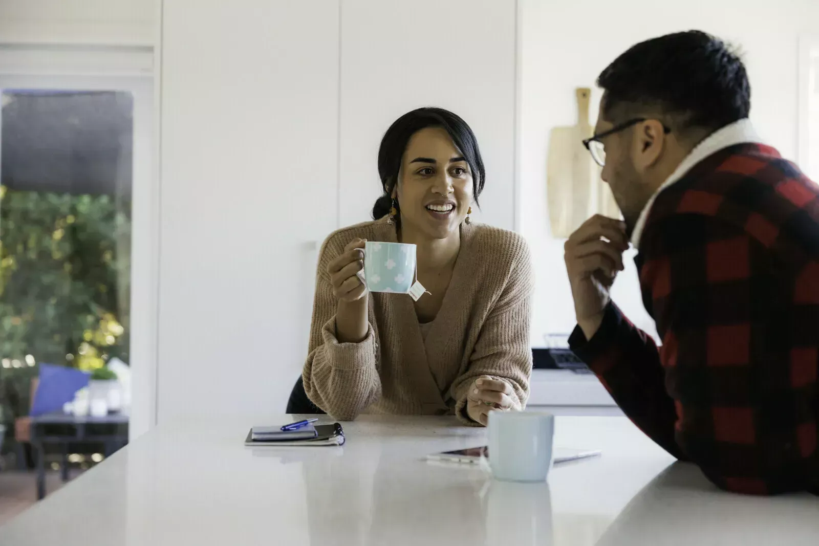 couple in the kitchen having a hot drink chatting