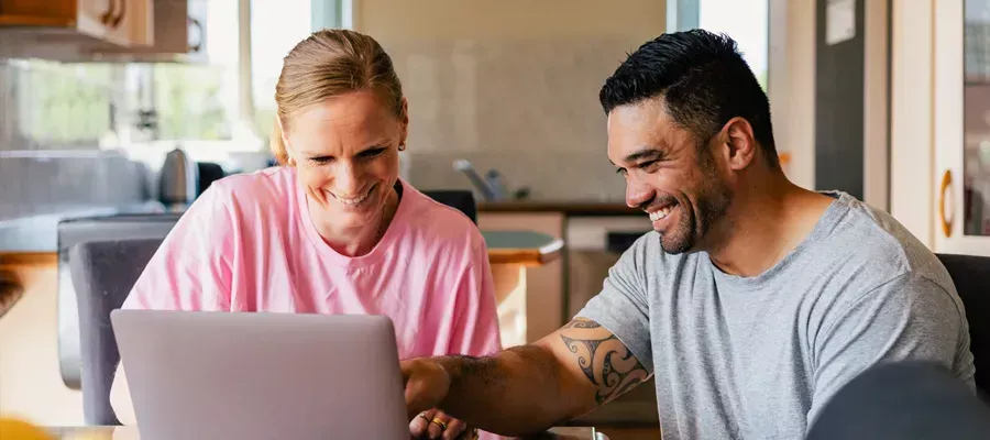 Couple together on a laptop, looking at Chubb client benefits.