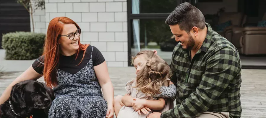 Family sitting together at home, reviewing Chubb multi-benefit insurance discounts.