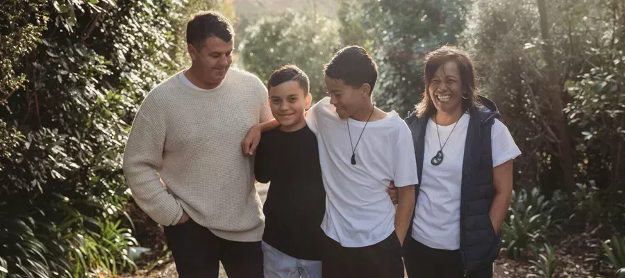 Family walking outdoors together, discussing Chubb lifetime reward discount.