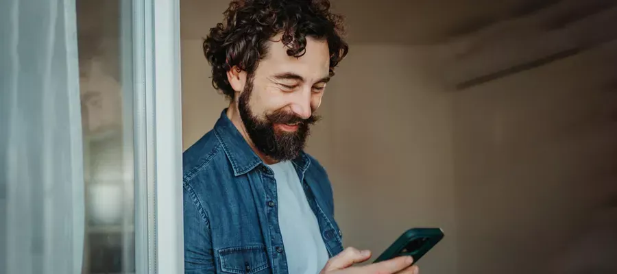 Male looking at Chubb client benefits on his smartphone