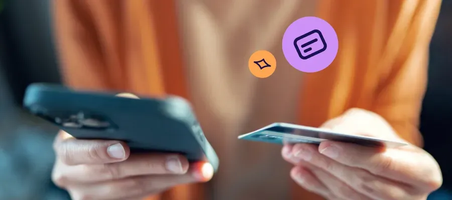 Person holding a smartphone and card to manage their TSB Mastercard