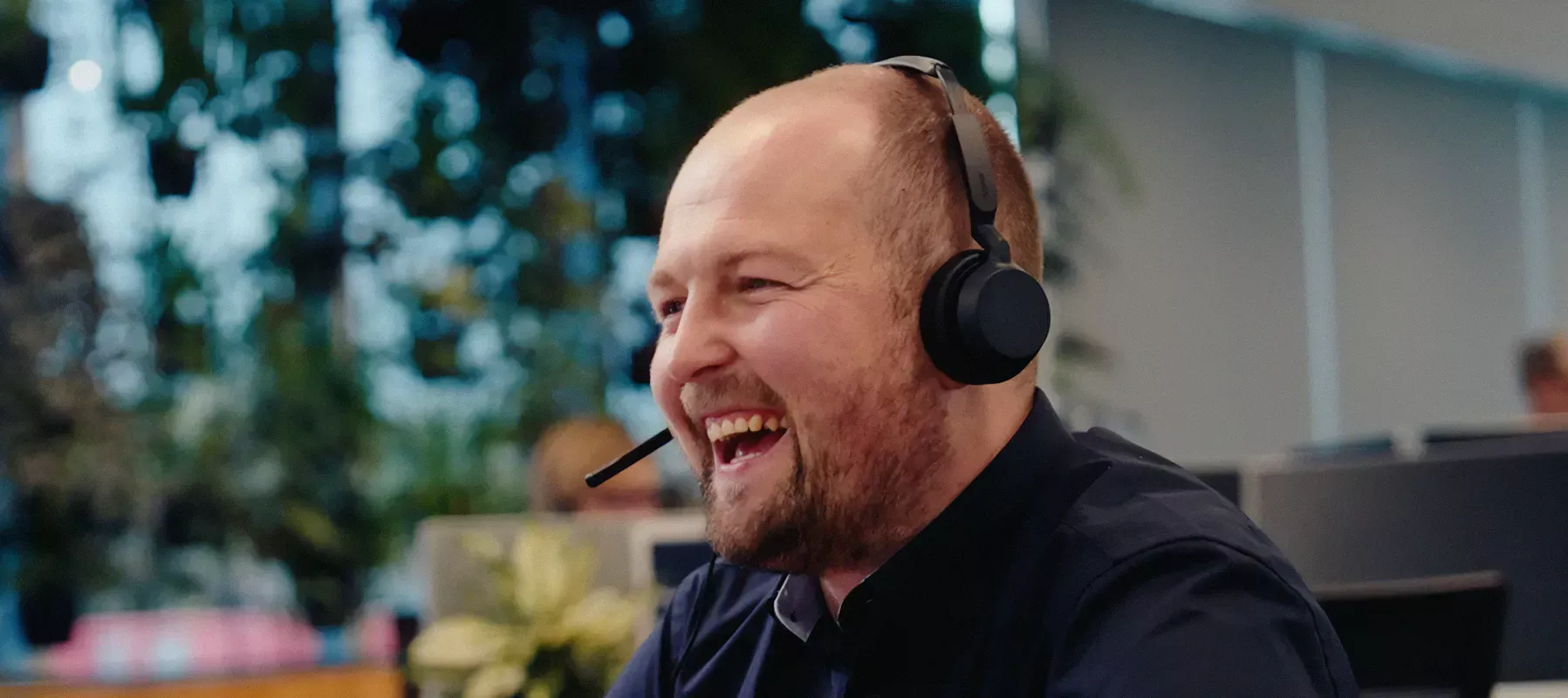 TSB customer support team member wearing a headset assisting a customer