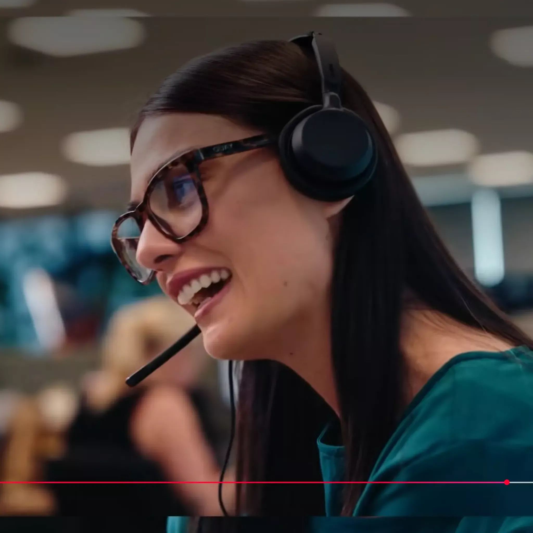 TSB staff member wearing a headset smiling talking on the phone to a customer